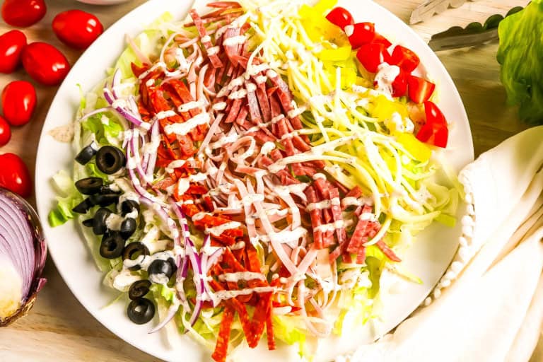 White plate with grinder salad
