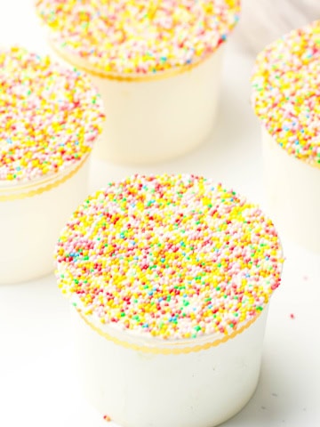 Four dessert cups with the dot cakes in them.